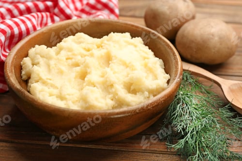 Preview: Bowl with tasty mashed potatoes on wooden table