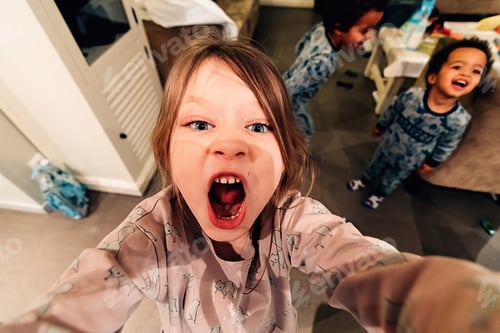 Preview: selfie of little girl playing and screaming in mobile phoneh