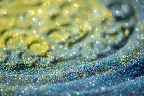 Preview: Abstract bright glitter lights colorful bokeh background in yellow, gold and blue color