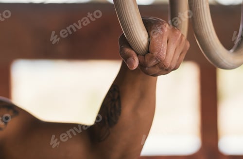 Preview: man hand holding a gymnastic ring. close-up