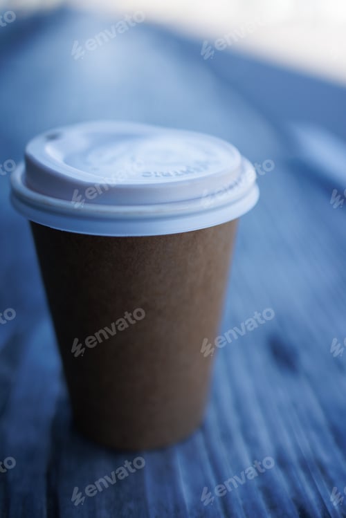 Preview: Vertical closeup shot of a brown paper coffee cup
