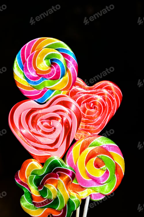 Preview: Top view of three multicolored lollipops isolated on dark blue background. Pin-up style