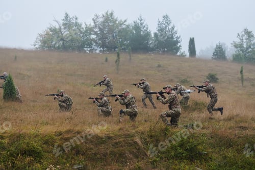 Preview: A disciplined and specialized military unit, donned in camouflage, strategically patrolling and