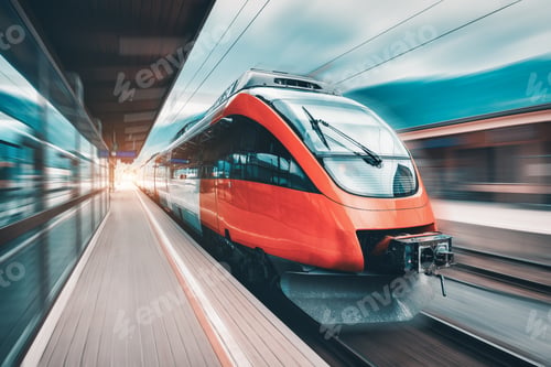 Preview: High speed orange train in motion on the railway station