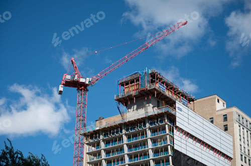 Preview: Modern cityscape featuring a tall building with a red crane situated on the roof