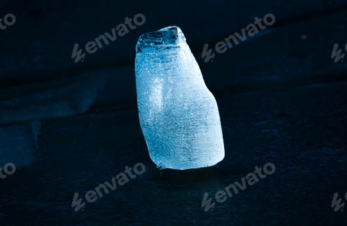 Preview: A piece of blue ice glows in the sun. Abstract blue cold ice. Big piece of ice.