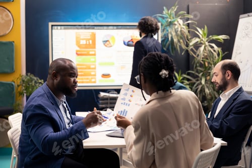Preview: Development team evaluating success and performance metrics on interactive board
