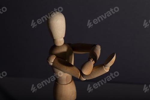 Preview: Wooden mannequin shows obscene gesture fuck off with hands on gray background. protest, riot