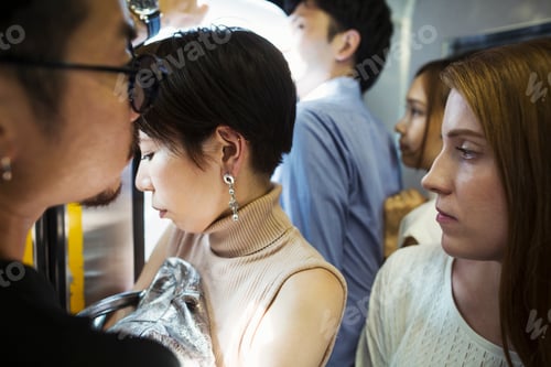 Preview: Small group of people standing on a subway train, Tokyo commuters.