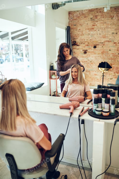Preview: Young blonde women smiling during a hair salon appointment