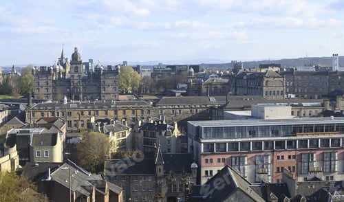 Preview: Beautiful view of buildings in Edinburgh, Scotland with a cloudy blue sky in the background