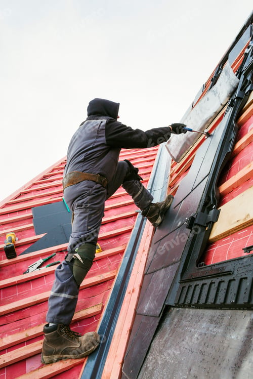Preview: A roofer replacing the tiles on a house roof.