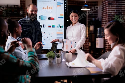 Preview: Startup business people talking and smiling at the end of late night sales meeting