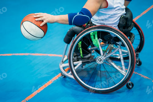 Preview: Disabled sport men in action while playing indoor basketball
