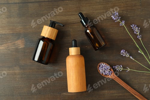 Preview: Lavender oil in bottles with lavender flowers on a dark background