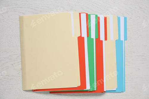 Preview: Many documents in folders on white wooden table, top view