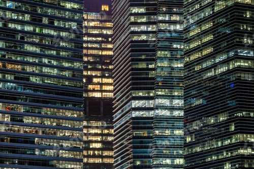 Preview: Pattern of office buildings windows illuminated at night. Lighting with Glass architecture facade