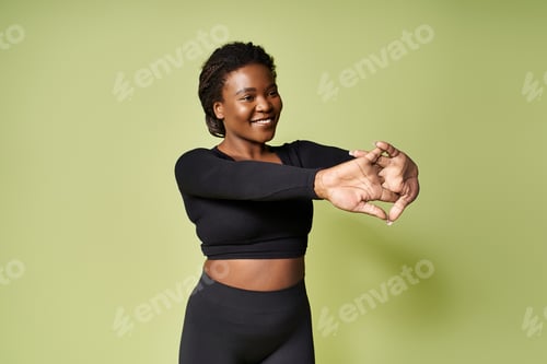 Preview: Empowering young African American athlete stretching in a vibrant studio