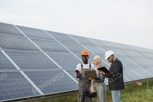 Preview: Multicultural people checking temperature of solar panels