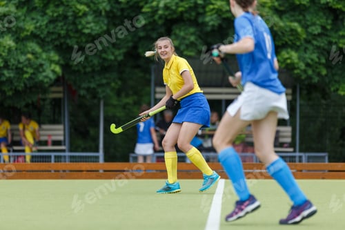 Preview: Young woman on the pitch playing field hockey game