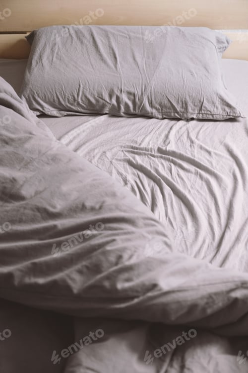 Preview: empty unmade bed with crumpled bedding or bedclothes