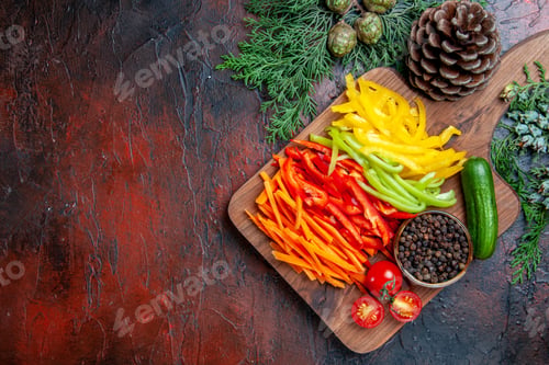 Preview: top view colorful cut peppers black pepper tomatoes cucumber on cutting board pine branches on dark