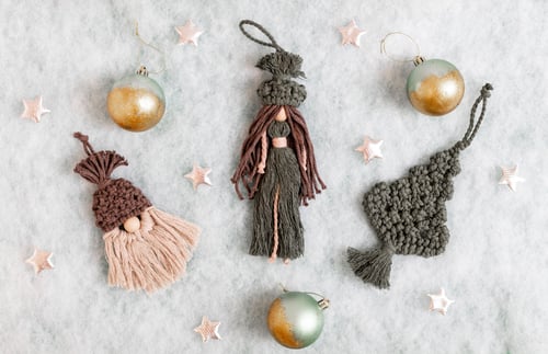 Preview: Three woolen knitted Christmas tree toys with Christmas balls on a white snowy background.