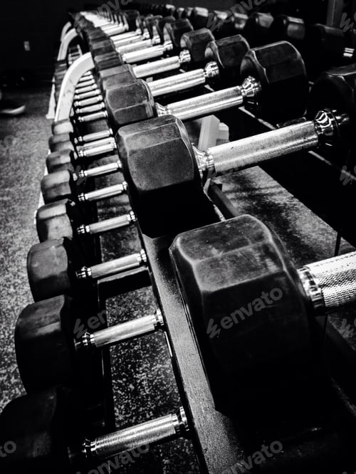 Preview: photo of barbells dumbbells weights in a gym for weightlifting and fitness or weight loss