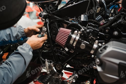 Preview: Man fixing a motorcycle in a modern workshop