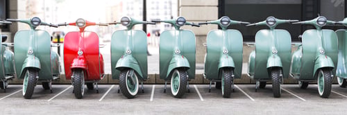 Preview: Vintage moped scooter in row on a parking of the city.