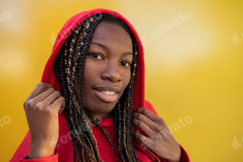 Preview: African girl natural beauty, portrait of person looking at camera yellow background
