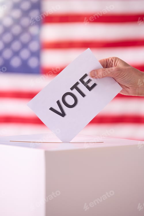 Preview: Hand Placing Vote In Ballot Box With American Flag Background