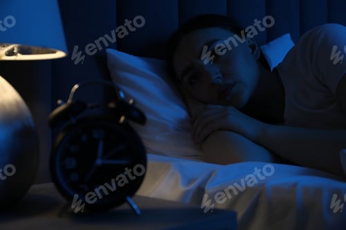 Preview: Frustrated woman suffering from insomnia in bed at home