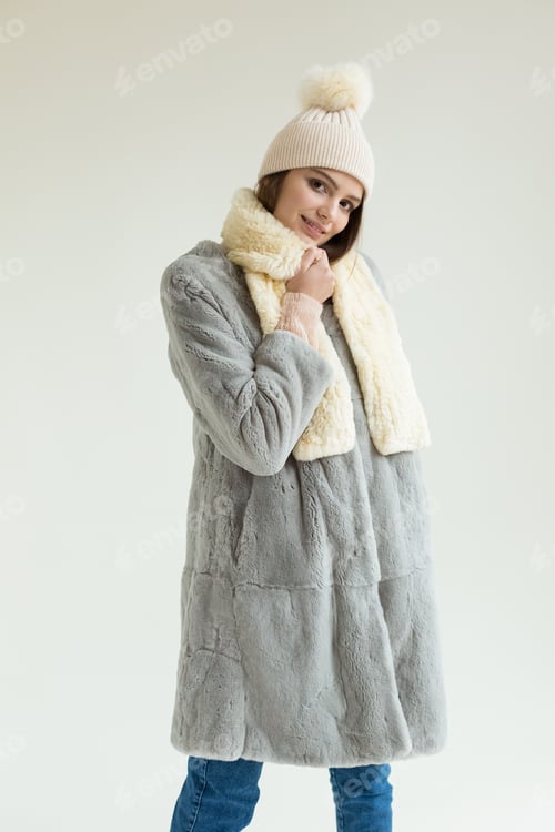 Preview: Young beautiful stylish woman in studio in coat, autumn fashion trend.