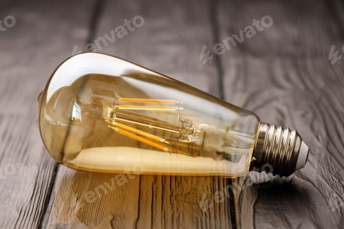 Preview: Light bulbs on dark wooden background close up