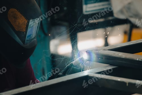 Preview: Industry worker welding iron pieces at work