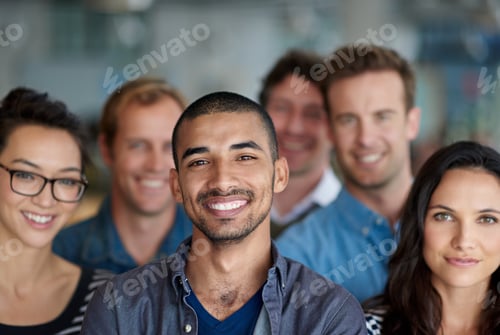 Preview: Feeling proud of our achievments. Shot of a smiling group of coworkers standing in an office.