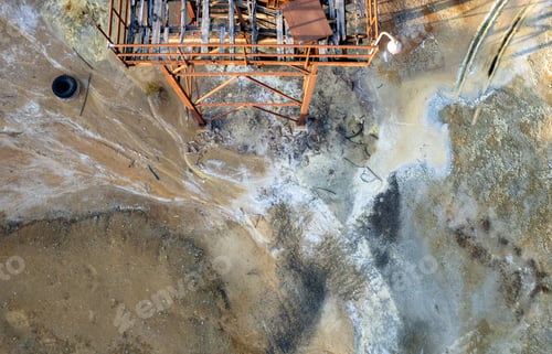 Preview: Aerial drone view of abandoned copper mine rusty structure with red toxic dry sand. Environmental
