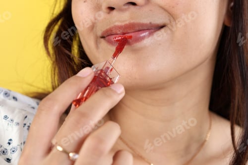 Preview: Asian Young Woman Applying Red Lip Tint