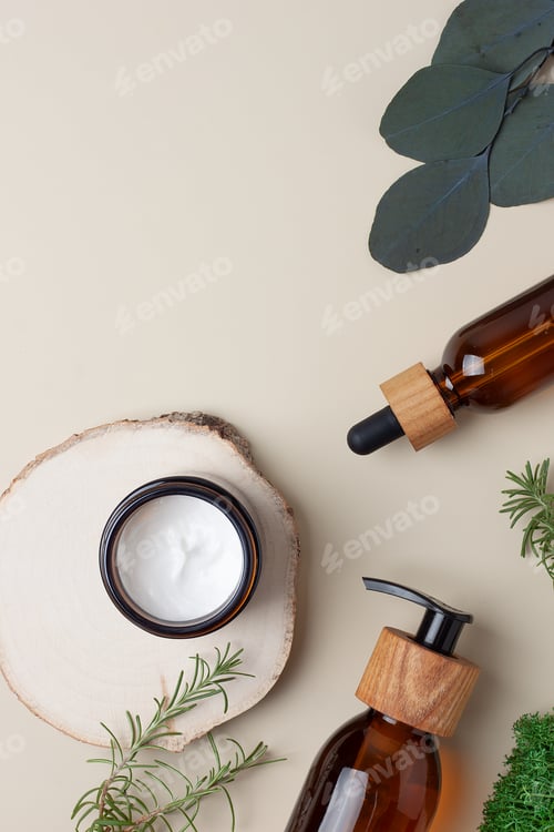 Preview: Cosmetic skin care products with eucalyptus and wood on beige background. Flat lay, copy space.