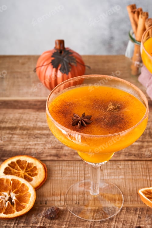 Preview: Pumpkin cocktail with cinnamon, orange juice and cocoa in glass mugs. Festive cocktail Halloween mar