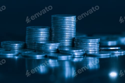 Preview: close up of money coin stack on black background with blue filter. Business and finance concept.