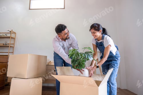 Preview: A couple moves into a new house. happily holding boxes and moving things together.
