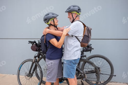 Preview: Active Senior Couple Embracing with Bicycles