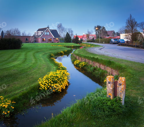 Preview: Landscape with beautiful house reflected in water canal at dusk