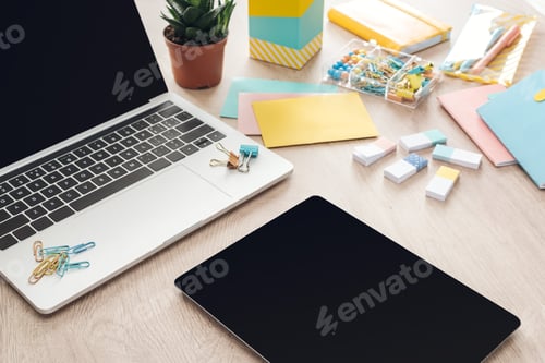 Preview: digital tablet, stationery and laptop on wooden table