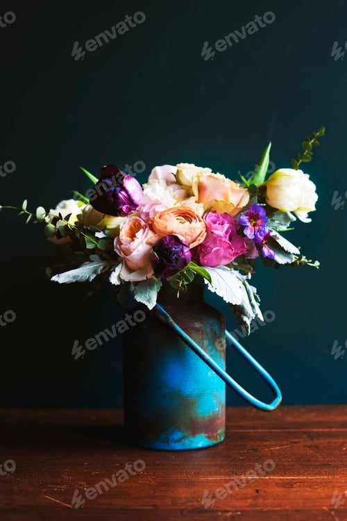 Preview: Various fresh flowers arrangement in metalic vase on wooden tabl