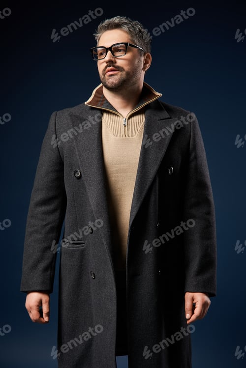 Preview: Stylish man in glasses showcases elegant outfit in a modern studio setting