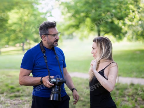 Preview: Backstage with model and photographer, in the session of photo shoots. Outdoors.