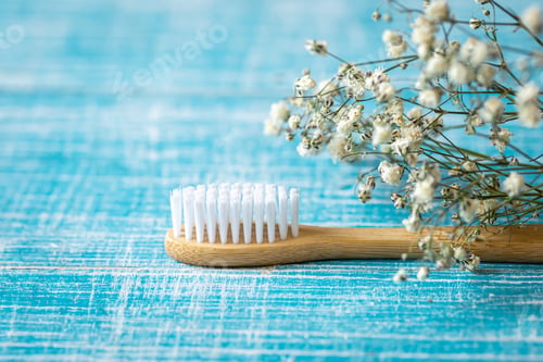 Preview: Natural eco-friendly bamboo toothbrush on a blue background, copy space.